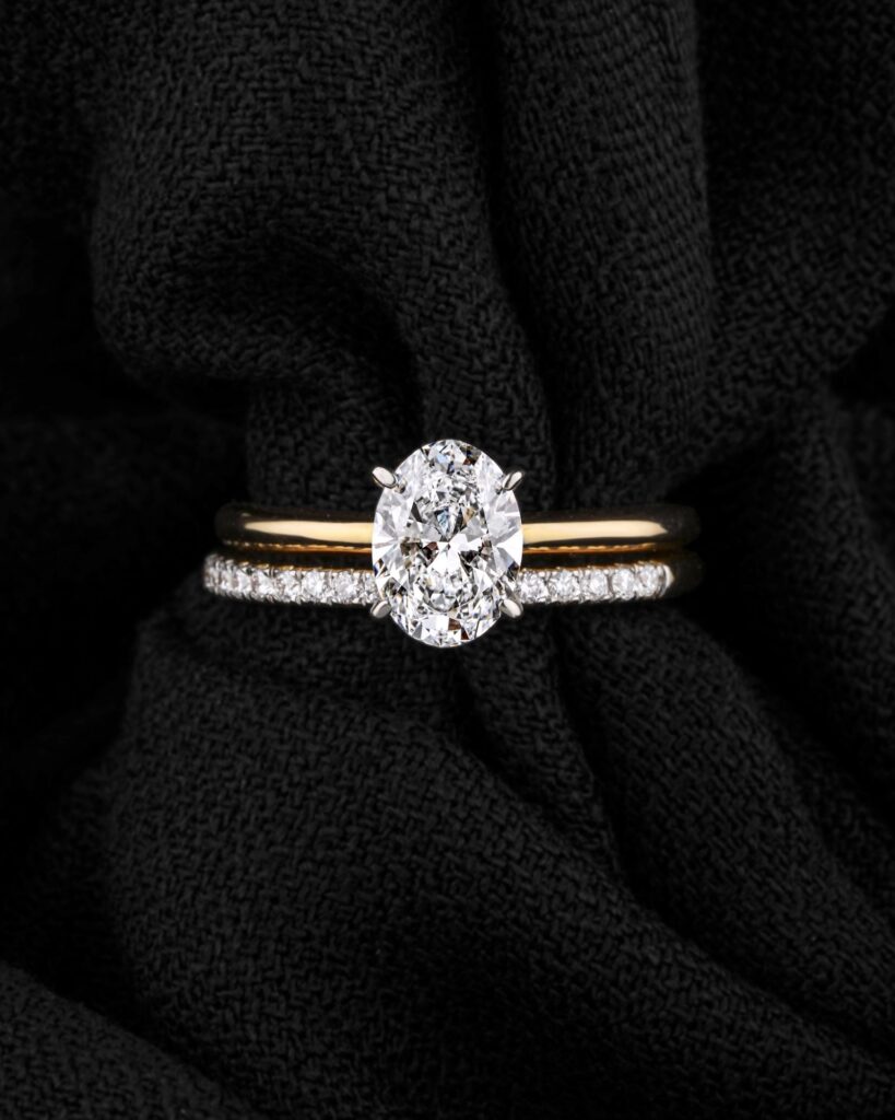 Diamond ring resting on dark textured fabric