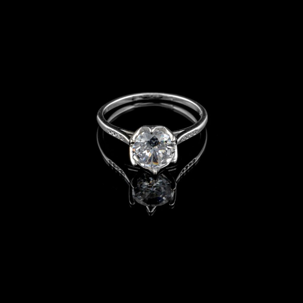 Diamond solitaire engagement ring on a black background